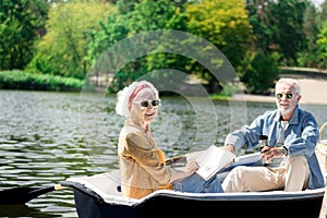 Cheerful pensioners smiling and enjoying boating together