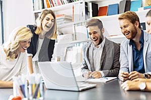 Cheerful people laughing in office