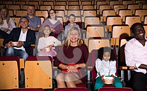 Cheerful people watching comedy in movie theater