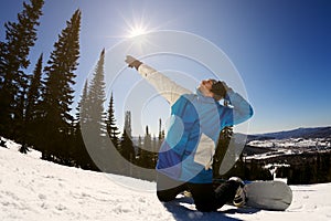 Cheerful person ready for winter ride on snowboard