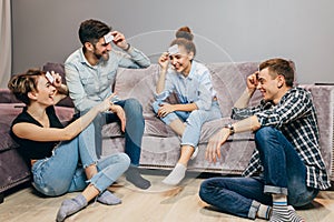 Cheerful pleasant gorgeous young people enjoy funny time in the living room