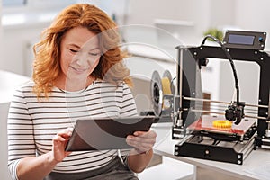 Cheerful pleasant woman using a tablet