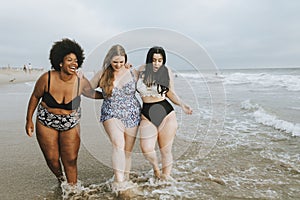 Cheerful plus size women enjoying the beach photo