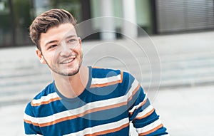 Cheerful portrait of a young man looking to side