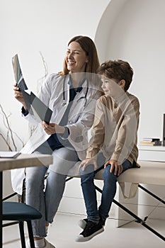 Cheerful practitioner reviewing Xray scan, shot of bones