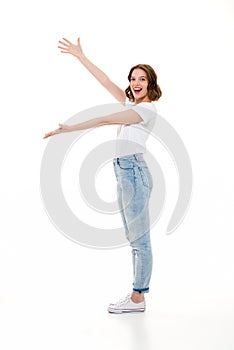 Cheerful pretty caucasian lady standing isolated showing copyspace.