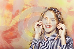 Cheerful pretty girl listens to music with earphones