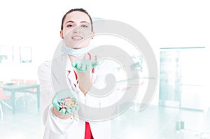 Cheerful pretty medic offering you capsules