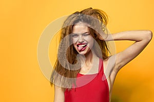 Cheerful pretty woman bright makeup red lips yellow background