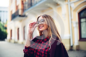 Elegant, trendy outfit Closeup of wrist watch on the hand of stylish woman. Fashionable girl on the street. Female fashion.