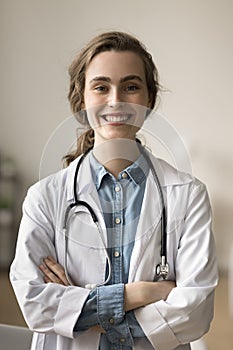 Cheerful pretty young medical practitioner woman posing in clinic office