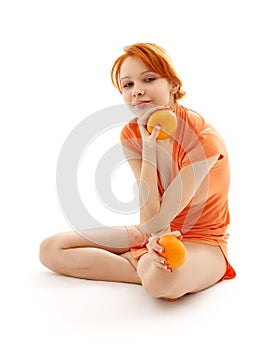 Cheerful redhead with two oranges