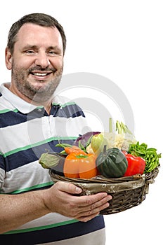 Cheerful retailer with a basket of vegetables