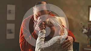 Cheerful retired couple dancing at home