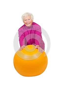 Cheerful retired lady with a pilates ball