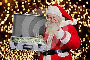 Cheerful Santa Claus with case of money.