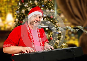 Cheerful Santa Claus playing piano and singing