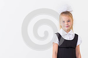 Cheerful school girl standing, isolated