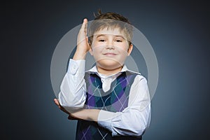 Cheerful Schoolboy ready to answer question isolated on gray background