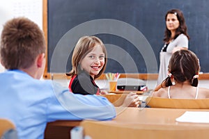 Cheerful schoolgirl in class room