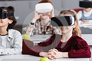 cheerful schoolkids gaming in vr headsets