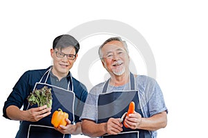 Cheerful senior asian father and middle aged son cooking together at kitchen, senior asian father and son with clipping path on