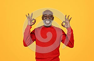 Cheerful senior Black man with white beard making the 'OK' sign with both hands
