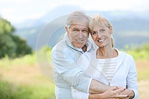 Cheerful senior couple in love outdoors