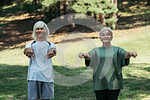 cheerful senior couple in sportswear exercising