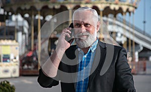 Cheerful senior man talking on mobile phone stock photo