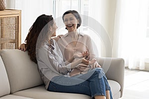 Cheerful senior mom and adult daughter woman meeting at home