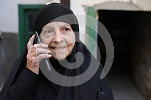 Cheerful senior muslim woman making a phone call