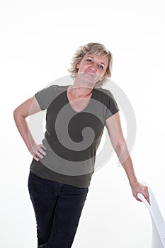 Cheerful senior sixties woman standing hair blonde near seat on white background
