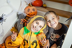 Cheerful siblings ready for halloween trick or treat