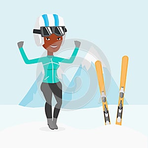 Cheerful skier standing with raised hands.