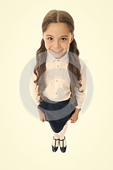 Cheerful smile. Girl cute pupil on white background. School uniform. Back to school. Student little kid adores school photo