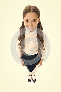 Cheerful smile. Girl cute pupil on white background. School uniform. Back to school. Student little kid adores school