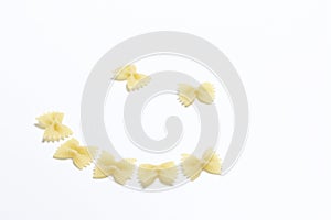 A cheerful smiley, laid out of pasta on a white surface.