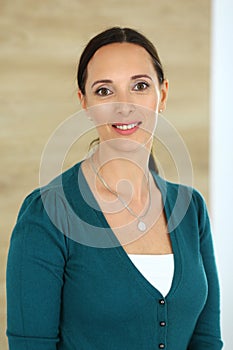 Cheerful smiling business woman standing straight in modern office. Middle aged female lawyer or auditor headshot