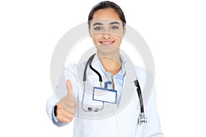 Cheerful smiling female doctor showing thumbs up, isolated over white background. Latin american or Hispanic young woman