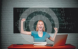 Cheerful smiling girl student at the blackboard. Education science people concept. Woman freelancer with good mood using