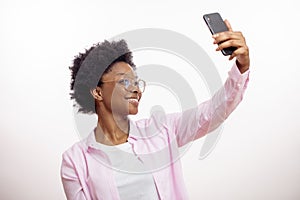 Cheerful, smiling, gorgeous, charming woman taking picture of herself