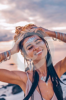 cheerful smiling young woman in elegant dress on the beach at sunset close up portrait