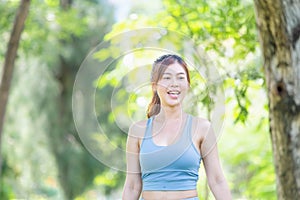 Cheerful sportswoman in the green park, Smile girl exercising outdoors, Healthy lifestyle concepts