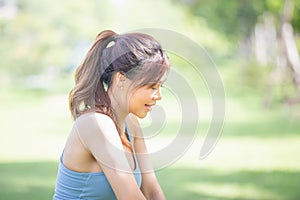 Cheerful sportswoman in the green park, Smile girl exercising outdoors, Healthy lifestyle concepts