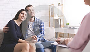 Cheerful spouses bonding at consultation with psychologist