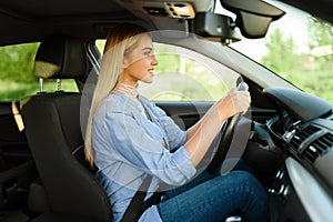 Cheerful student in car, lesson in driving school