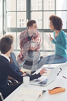 Cheerful students having a funny loud conversation during break