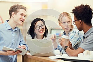 Cheerful students talking in library