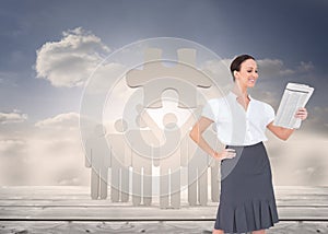 Cheerful stylish businesswoman holding newspaper